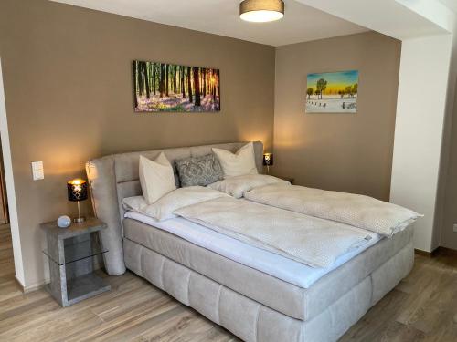 a couch in a room with a painting on the wall at Im Kurpark in Bad Ischl