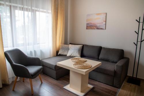 a living room with a couch and a table at Червената къща in Perushtitsa
