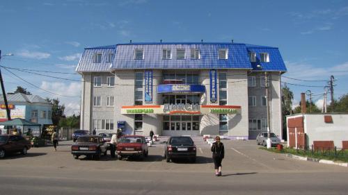a large building with a blue roof on a street at TGK Zaraisk in Zaraysk