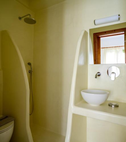 a bathroom with a white sink and a shower at Studios Marios in Kamari