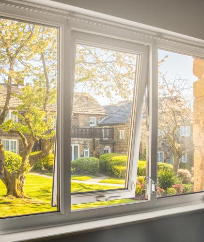 a window with a view of a yard at Last Drop Village Hotel & Spa in Bolton