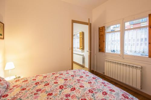 a bedroom with a bed and a window at Can Prat Solei in Ripoll