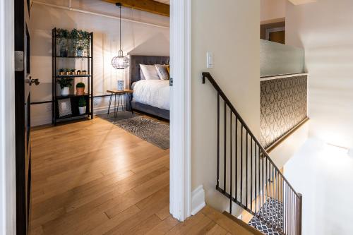 a hallway leading to a bedroom with a bed at Les Lofts St Jean in Quebec City