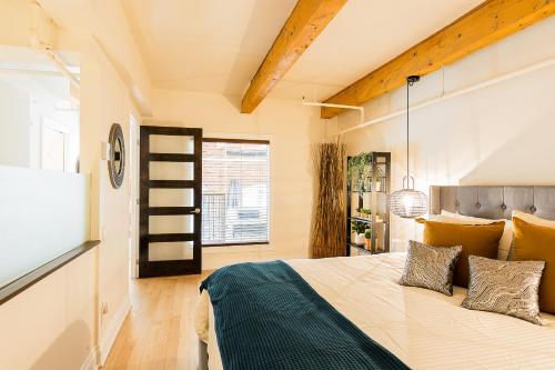 a bedroom with a bed and a tv in a room at Les Lofts St Jean in Quebec City