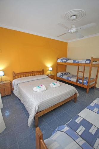 a bedroom with two beds and two bunk beds at Las Cabañas in Colorado River