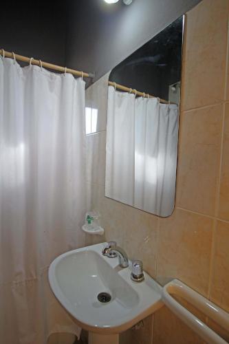 a bathroom with a sink and a mirror at Las Cabañas in Colorado River