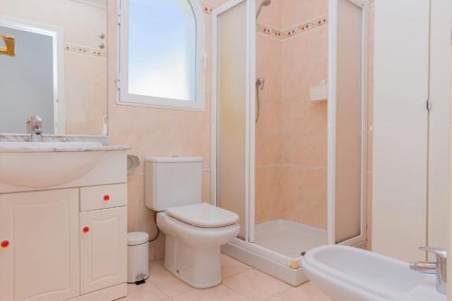 a bathroom with a toilet and a shower and a sink at Salonica Duplex I Penthouse Javea Arenal by Rock Rentals in Jávea