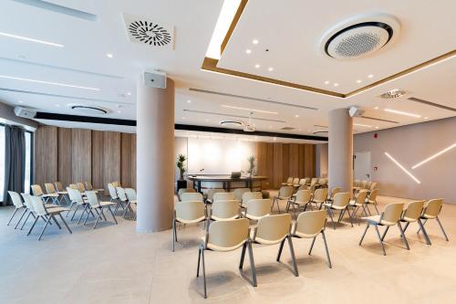 a conference room with chairs and a podium at Waldorf Palace Hotel in Cattolica