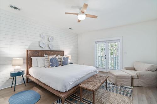 a white bedroom with a bed and a couch at 248 Beach Bike Way in Inlet Beach