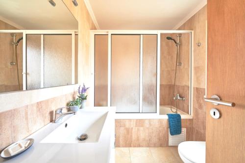 a bathroom with a tub and a sink and a shower at Idyllic Lisbon Apartments With Amazing Courtyard, By TimeCooler in Lisbon
