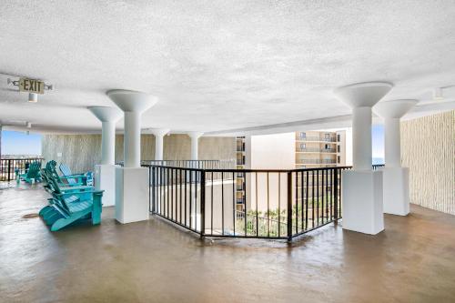 a lobby with columns and a staircase in a building at The Top of the Gulf #612 in Panama City Beach