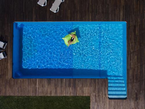 a blue cake with a person in a swimming pool at Quinta do Freixo in Benafim