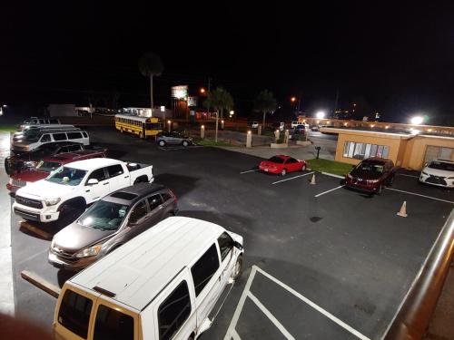 a parking lot with cars parked in a parking lot at Relax Inn Silver Springs in Silver Springs