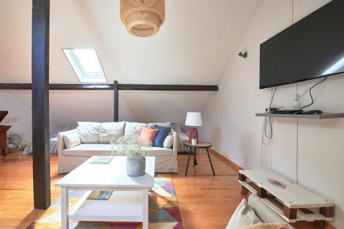 a living room with a couch and a table at Idyllic Lisbon Apartments With Amazing Courtyard, By TimeCooler in Lisbon