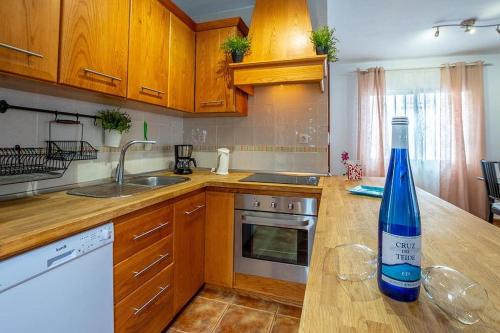 a kitchen with a bottle of wine on a counter at Villa Rosa in Callao Salvaje