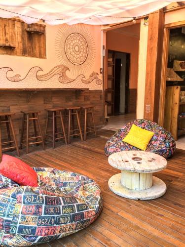 a patio with two chairs and a table at Duque Hostel in Florianópolis