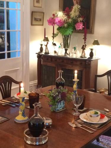a dining room table with candles and flowers on it at Ingram House Bed & Breakfast in Alnwick