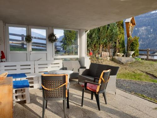a patio with chairs and a table with a view at Hofstätter Ferienwohnung in Fliess
