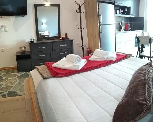 a bedroom with a bed with two towels on it at 3SSS Bouquet Studios in Marmarion