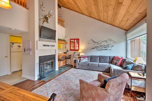 a living room with a couch and a fireplace at Lincoln Condo with Amenities and Shuttle to Loon! in Lincoln