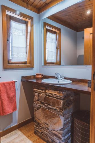 a bathroom with a stone counter with a sink at Casa das Santiagas em Arouca in Arouca
