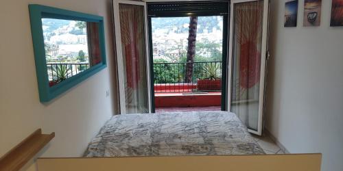 a bedroom with a bed and a large window at Residence Eurotel da Nella e Stefano in Rapallo