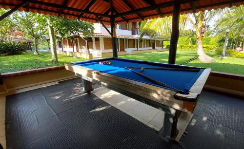 a pool table in a pavilion with a pool at Casa Campestre Sol Y Luna in Quimbaya
