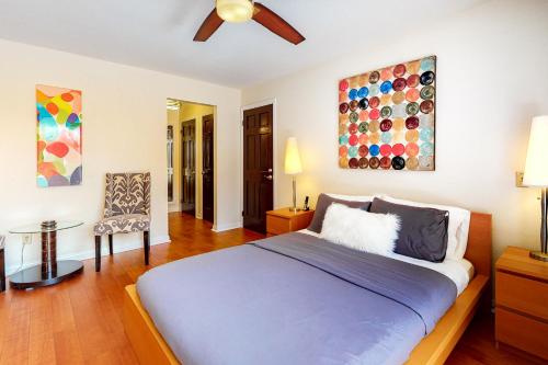 a bedroom with a bed and a painting on the wall at Caballeros Condo in Palm Springs