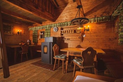 a kitchen with a table and chairs in a cabin at Lesachtalerhof in Liesing