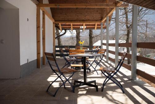 a patio with a table and chairs on a deck at KONAK LJUBICA Rtanj in Boljevac