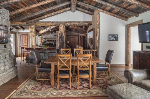 a dining room with a wooden table and chairs at Hobbit House in Big Sky