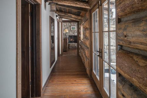 a hallway in a house with wooden floors and windows at Hobbit House in Big Sky