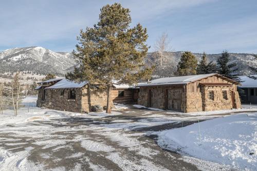 a couple of buildings with snow on the ground at Hobbit House in Big Sky