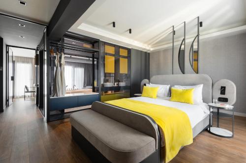 a bedroom with a large bed and a couch at COLORS Hotel Athens in Athens