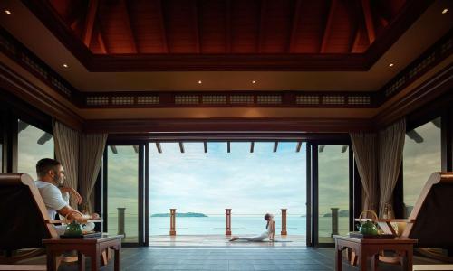 a man and woman in a room with a view of the ocean at Shangri-La Tanjung Aru, Kota Kinabalu in Kota Kinabalu
