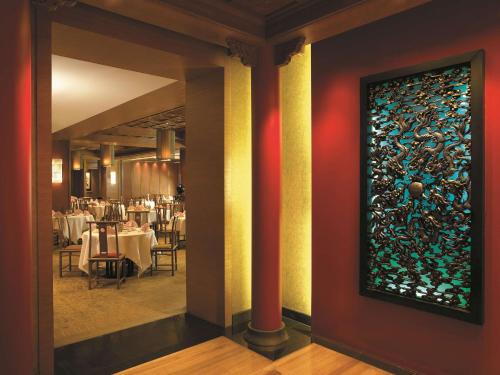 a dining room with a stained glass window on the wall at Shangri-La Kuala Lumpur in Kuala Lumpur