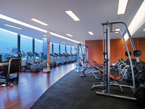 a gym with rows of treadmills and machines at Shangri-La Jakarta in Jakarta