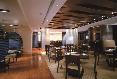 a dining room with tables and chairs in a restaurant at Kowloon Shangri-La, Hong Kong in Hong Kong