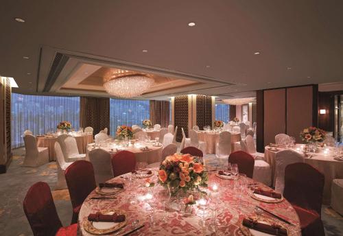 a banquet room with tables and chairs and tablesearcher at Kowloon Shangri-La, Hong Kong in Hong Kong