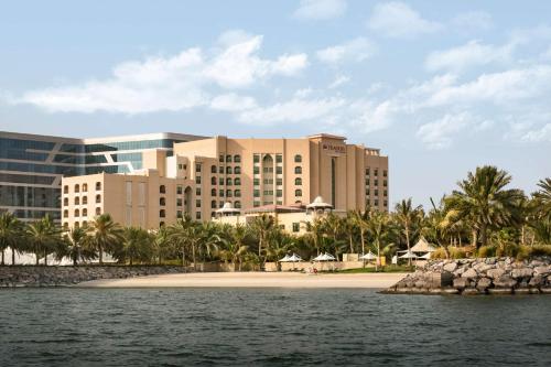 a resort from the water with a beach and buildings at Traders Hotel, Abu Dhabi in Abu Dhabi
