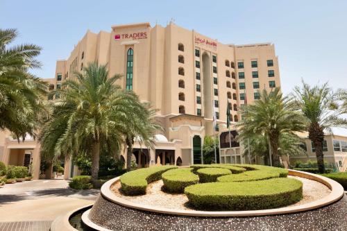 a resort with a large building with a hedge at Traders Hotel, Abu Dhabi in Abu Dhabi