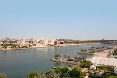 a view of a river with a city in the background at Traders Hotel, Abu Dhabi in Abu Dhabi