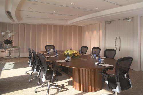 a conference room with a wooden table and chairs at Shangri-La Far Eastern Tainan in Tainan