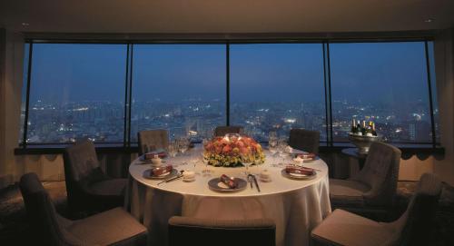 a table in a room with a view of a city at Shangri-La Far Eastern Tainan in Tainan