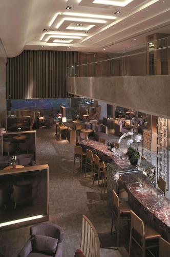 a restaurant with tables and chairs and a bar at Shangri-La Far Eastern Tainan in Tainan