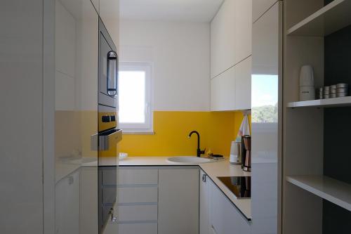 A kitchen or kitchenette at Apartman No 12