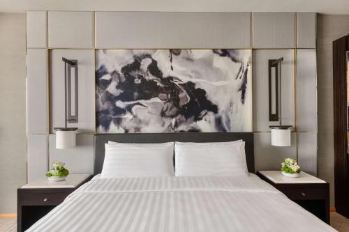 a bedroom with a large white bed with two night stands at Shangri-La Dubai in Dubai