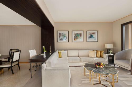 a living room with a white couch and a table at Shangri-La Dubai in Dubai