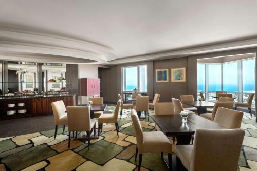 a living room filled with furniture and a large window at Shangri-La Dubai in Dubai