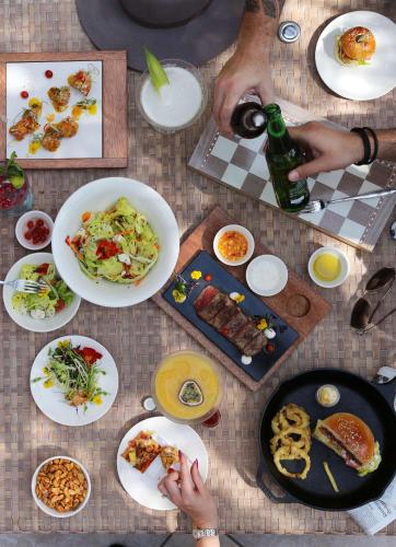 a table with plates of food and a bottle of wine at Shangri-La Dubai in Dubai
